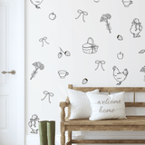 Cottage-style decals on white wall with bench and pillows