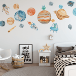 Kids' bedroom featuring colorful space-themed wall decals, including planets, rockets, astronauts, and aliens, adding a playful and educational touch