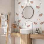 Bathroom with minimalist Swan Princess wall decals in soft pink tones, featuring a round mirror and natural wooden counter decor.