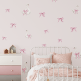 Swan and bow decals styled in a girly bedroom, featuring a soft pink and white theme with a cozy bed and elegant decor.