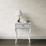 A serene scene with a console table against a wall adorned with swimming swan wallpaper in soft beige tones, featuring a lamp, a cup, and a small vase of flowers