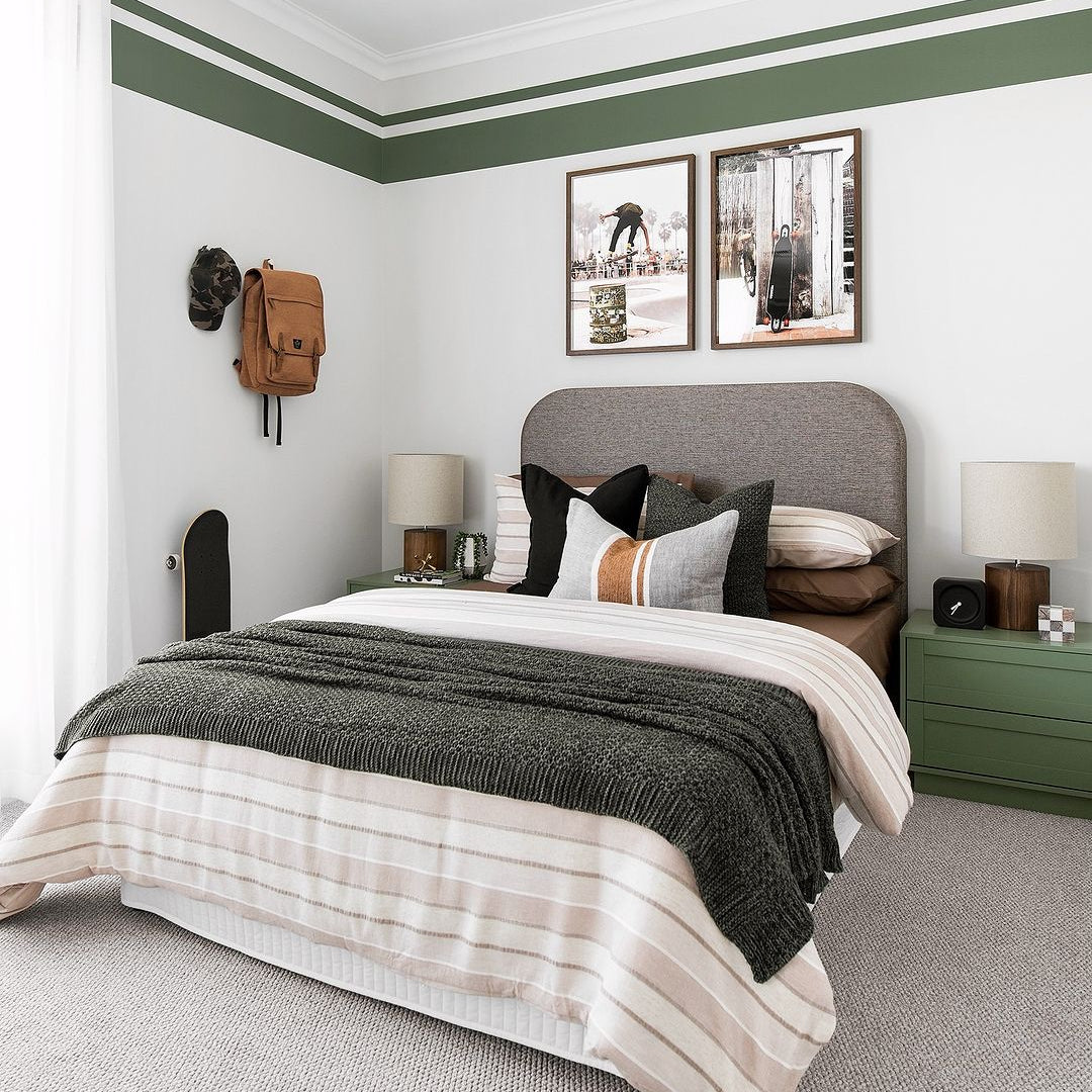 Modern bedroom with green and white thick and thin stripe wall border decals, creating a stylish accent around the room.