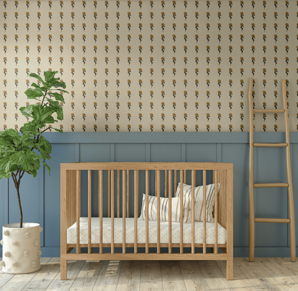 Nursery decorated with Vintage Aster Wallpaper, small floral design paired with wooden crib and blue wainscoting