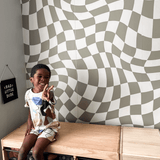 Customizable wavy check wallpaper in soothing neutral tones adds a playful yet sophisticated touch to any room. Perfect for nurseries or playrooms. Peel-and-stick, easy to apply and remove, ideal for renters and redecorators looking to personalize their space