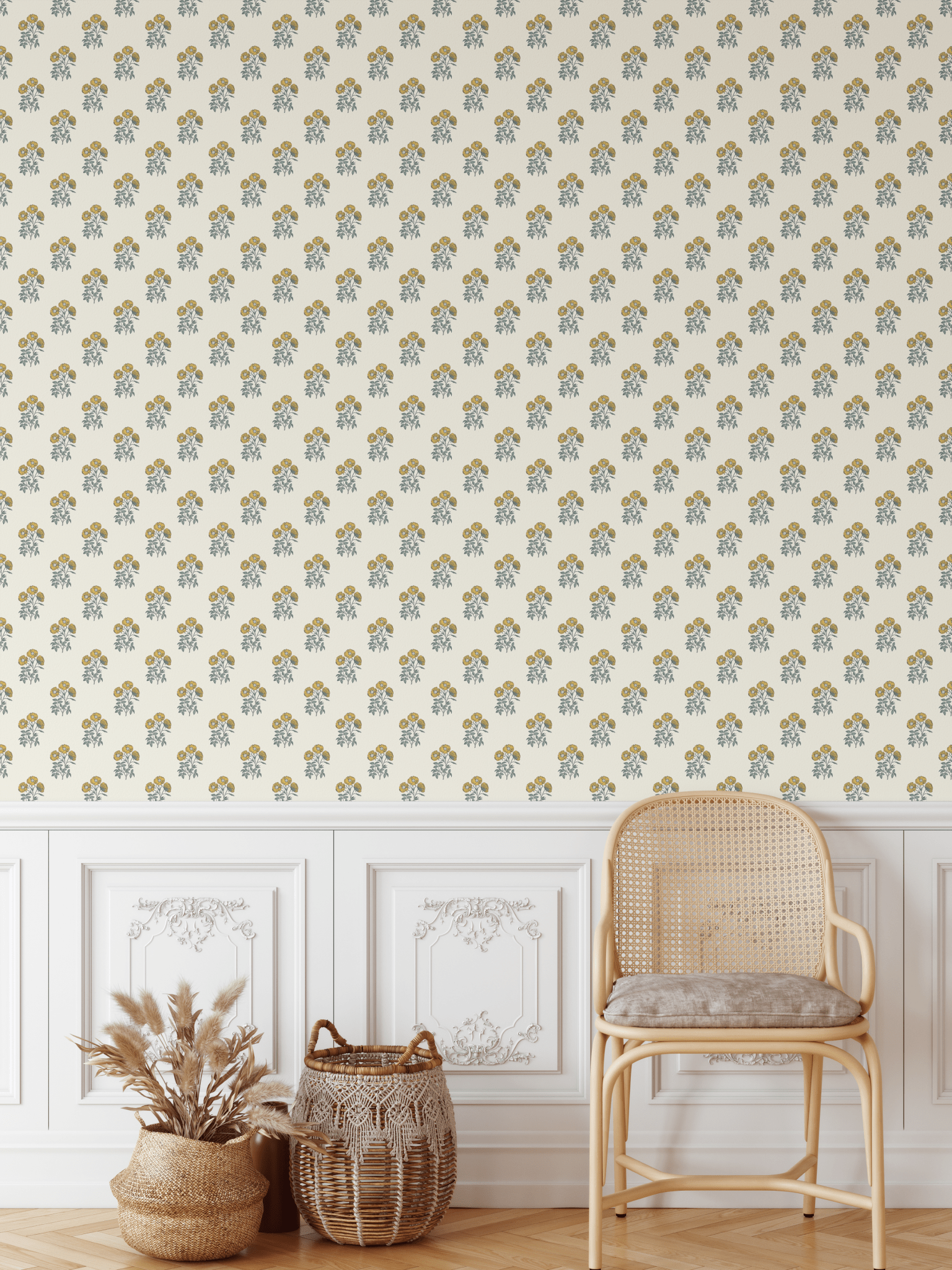 Vintage yellow floral block print wallpaper in a rustic living room with white wainscoting and a rattan chair.