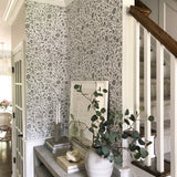 Modern entryway with greenery and grey floral wallpaper