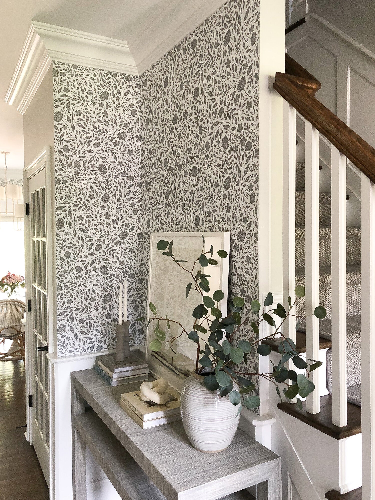 Modern entryway with greenery and grey floral wallpaper