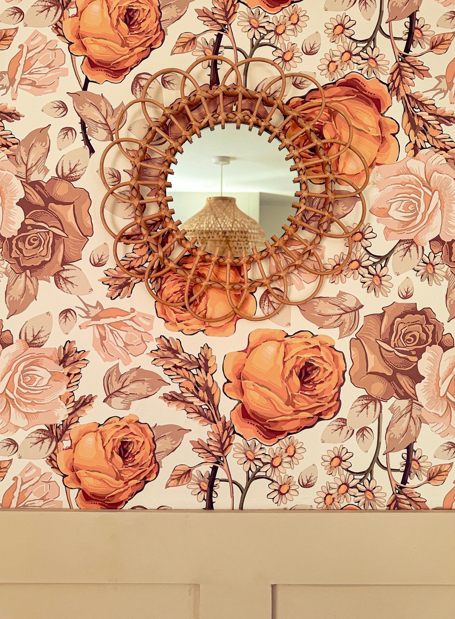 Bohemian orange, brown and cream wallpaper with decorative bamboo mirror.