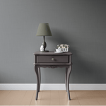 Charcoal grey grasscloth self adhesive removable wallpaper behind living room furniture
