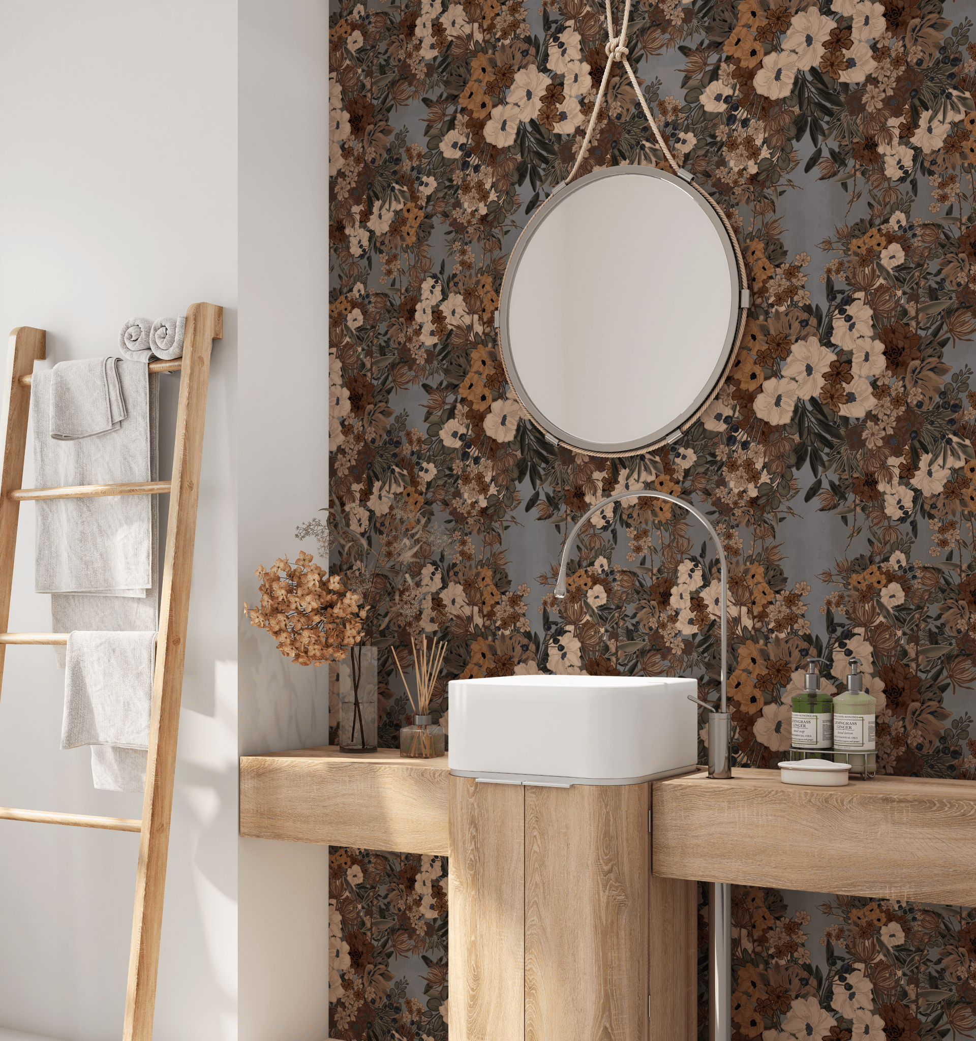 A bathroom featuring a round mirror above a white basin, set against a wall adorned with classic floral wallpaper in earth tones.