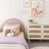 Cream floral Beige Wall Paper in a room with pink bed and purple bedding and flower art