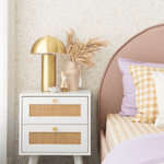 Flowers in cream beige wallpaper in a room with a gold lamp and pampas