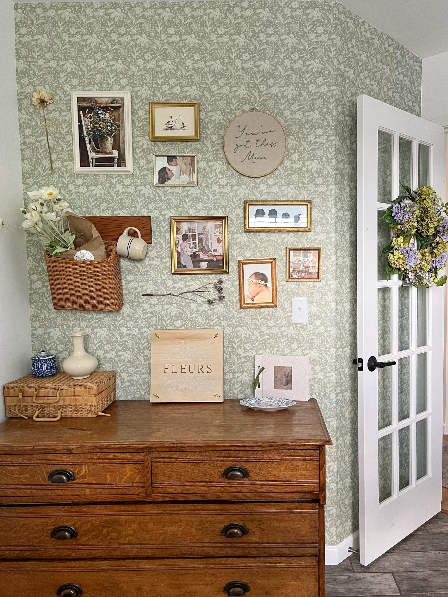 Office wall with rustic decor and sage green wallpaper