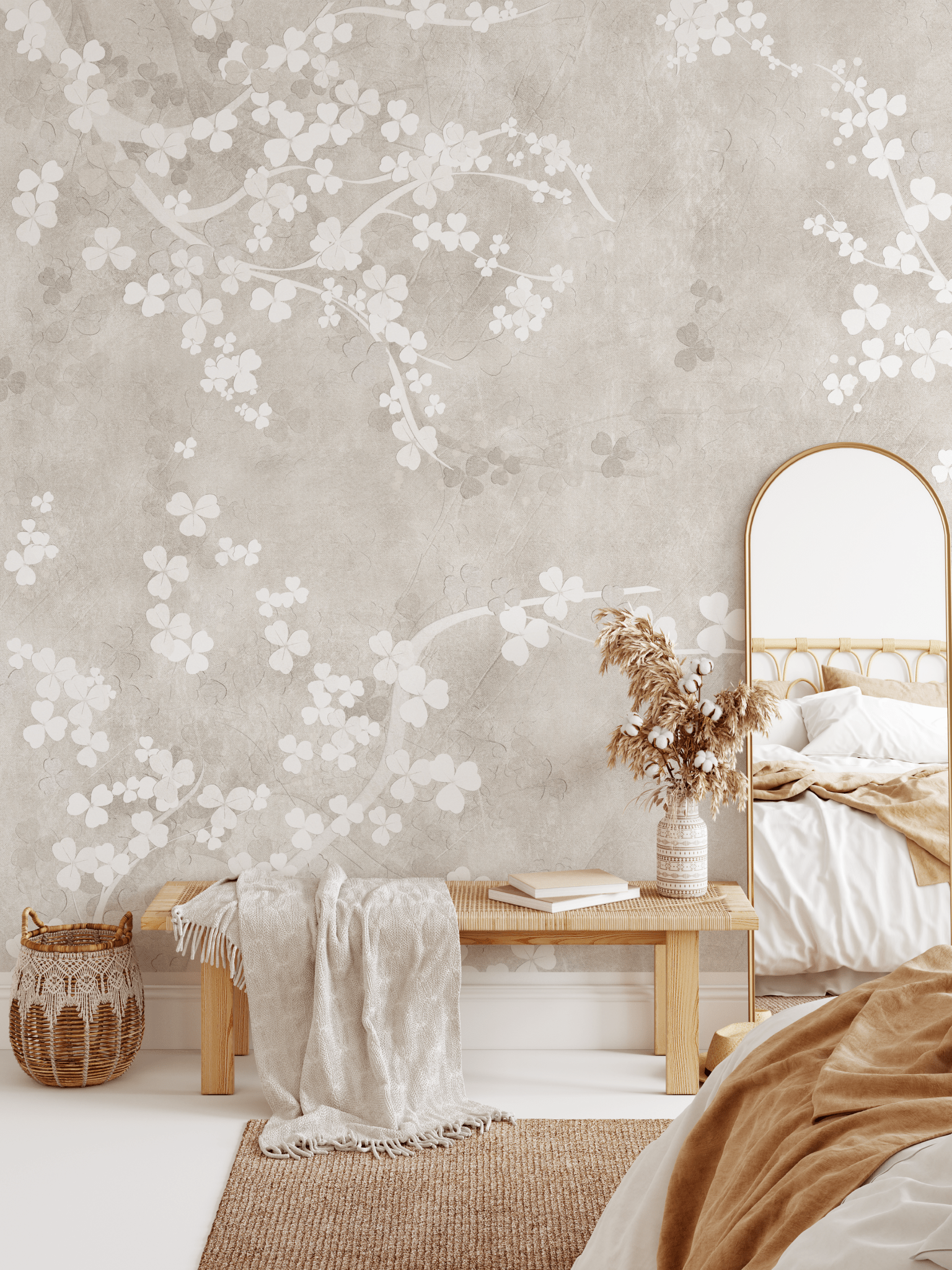 A bedroom featuring a natural beige fresco wall mural with a delicate floral pattern, a gold-framed mirror, and earth-toned bedding