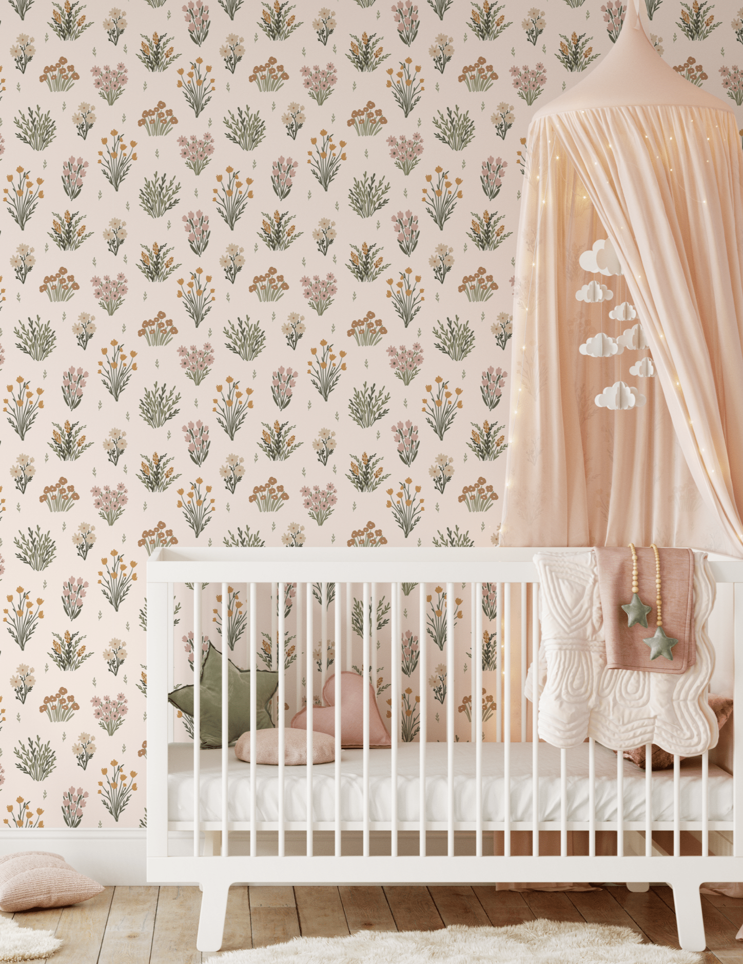 A nursery room featuring walls covered in pastel floral wallpaper, with a white crib and a soft pink canopy.