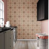Modern laundry room with dusty rose picnic-pattern peel and stick wallpaper, contrasting black cabinetry, and woven laundry baskets