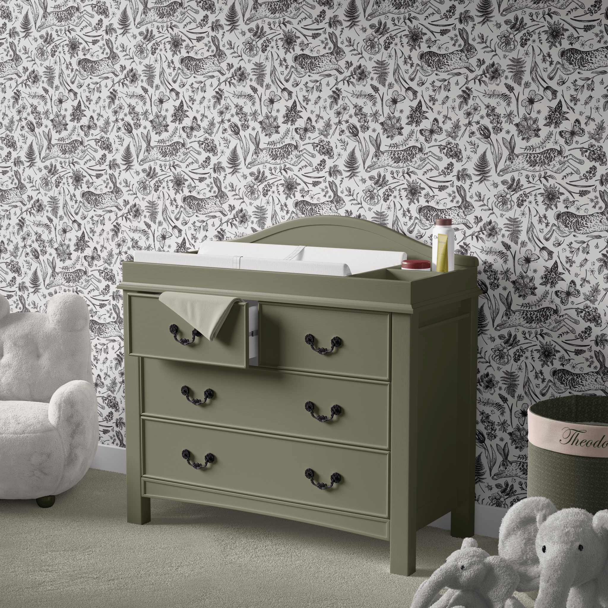 Chic and timeless monochrome peel and stick wallpaper featuring a whimsical pattern of bunnies, flowers, and butterflies, creating an elegant and playful atmosphere in a baby's nursery with a classic green changing table