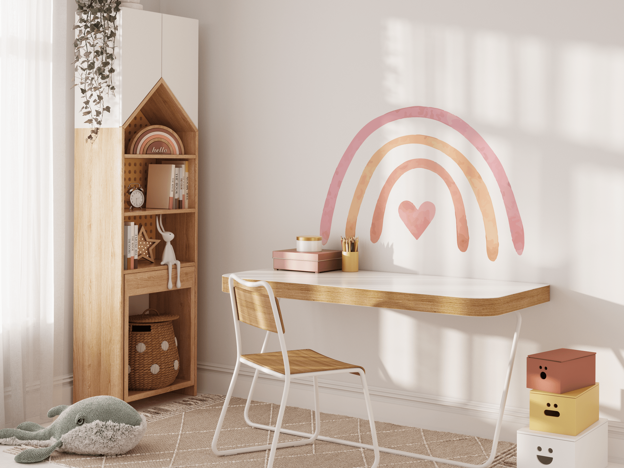 A bright and airy homeschool or study room for a child with a pastel rainbow wall decal. This room features a wooden bookshelf filled with supplies, a minimalist desk with a white chair, and playful elements like a stuffed octopus toy and colorful storage boxes.