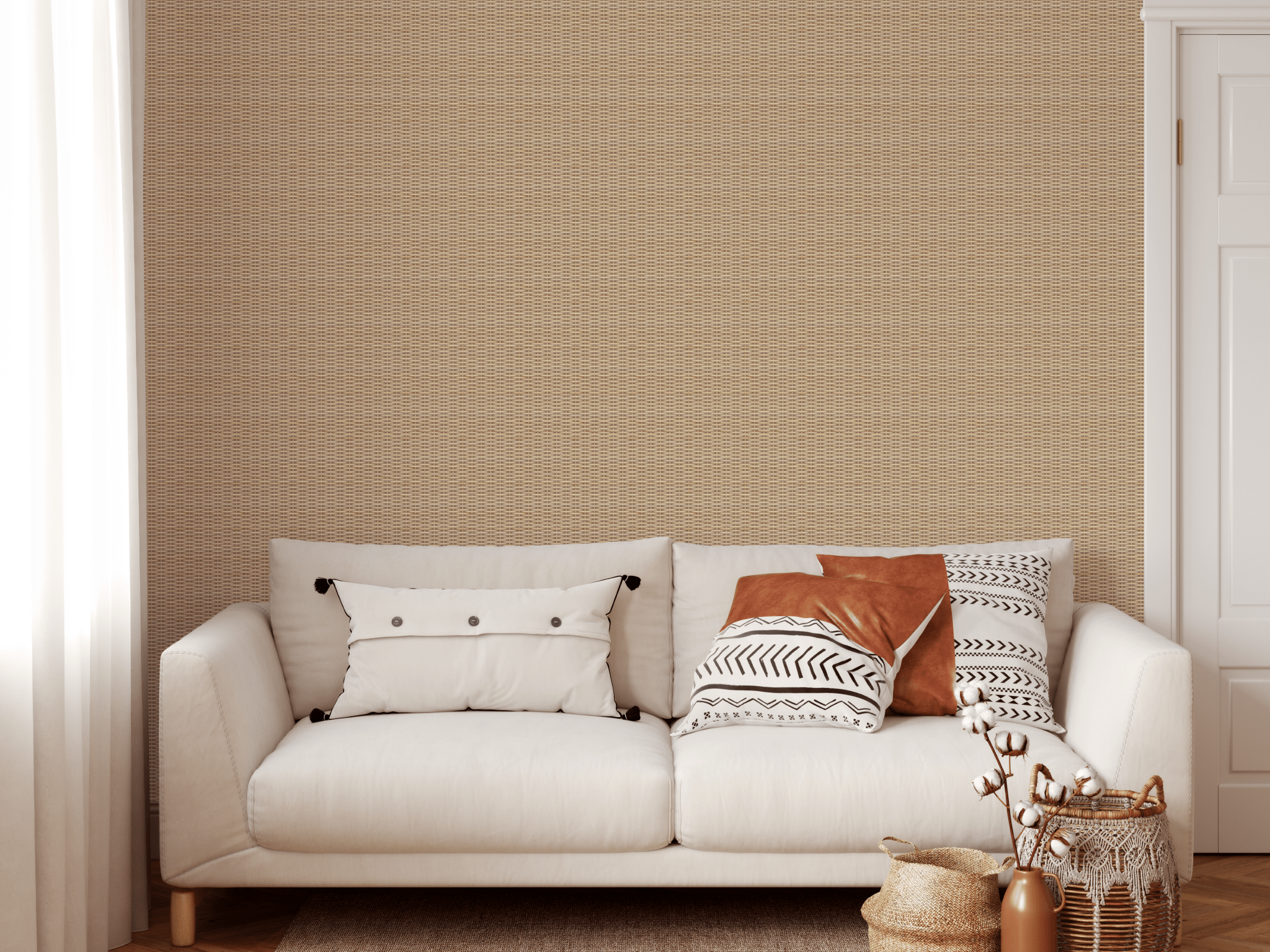 A cozy living space decorated with natural rattan weave wallpaper, a comfortable cream sofa adorned with stylish patterned pillows, and a bohemian-style woven basket with branches
