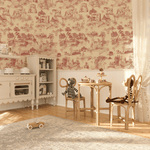 Vintage red toile de Jouy wallpaper with pastoral farm scenes in a cozy nursery room setup, featuring wooden children's furniture and toys.
