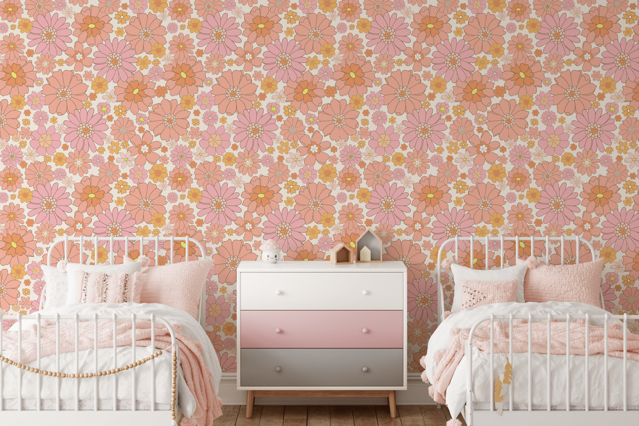 Charming children's bedroom with retro floral peel and stick wallpaper in shades of pink and orange, complemented by white and pink bedding and a stylish ombre dresser.