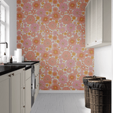 Modern laundry room design featuring retro floral removable self-adhesive wallpaper, creating a lively and cheerful backdrop against the contrast of white cabinetry and dark countertops.