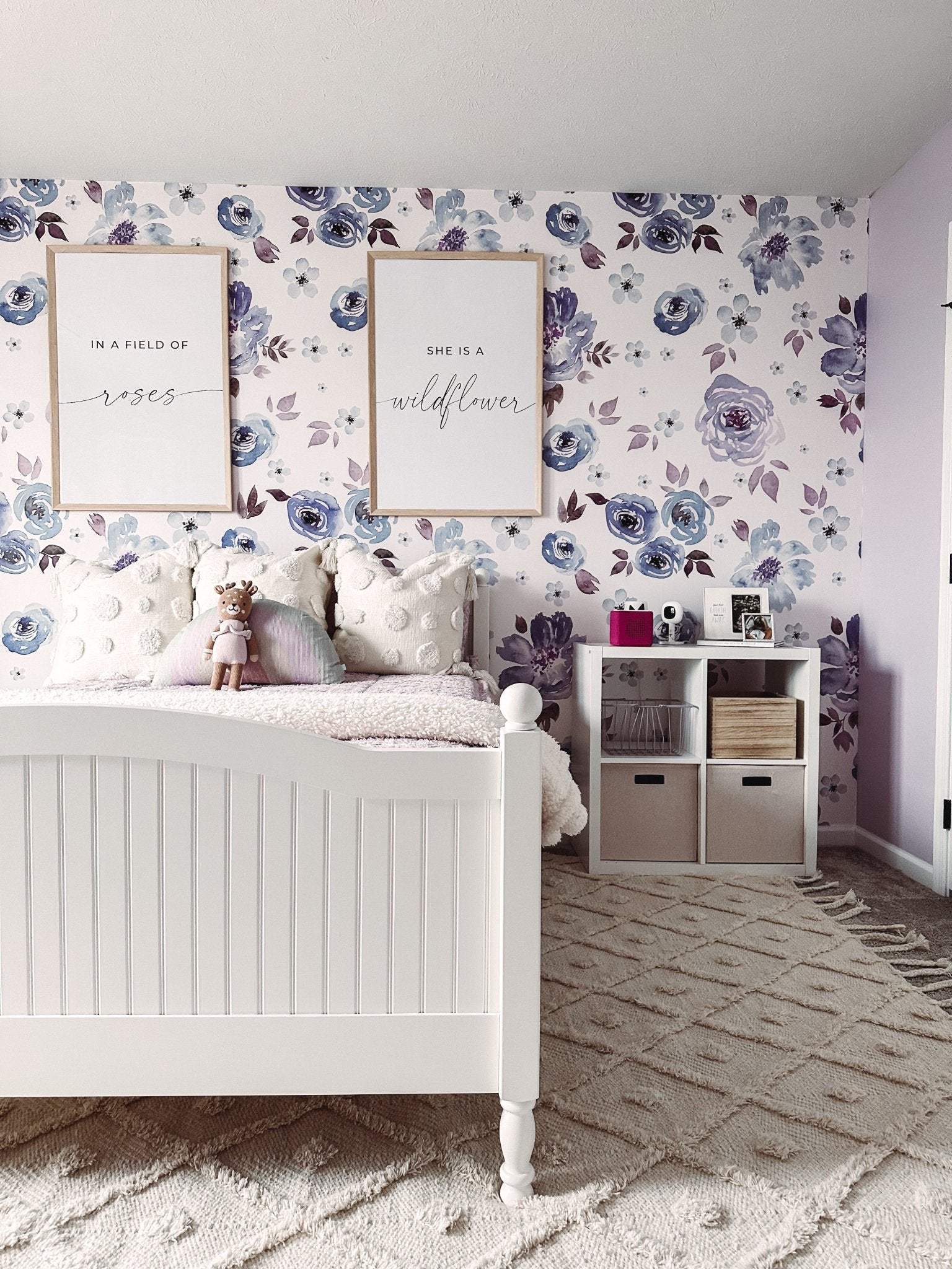 Girls room featuring purple floral peel and stick wallpaper