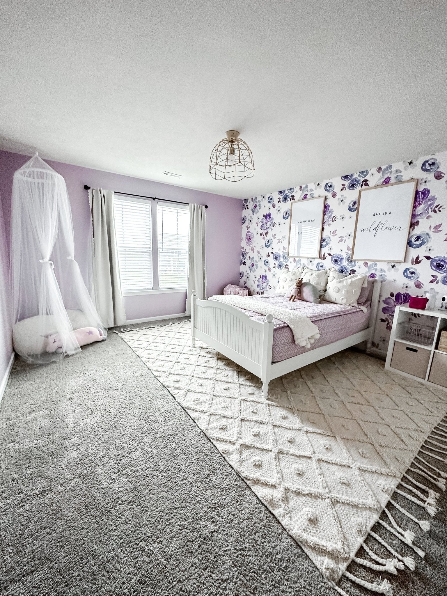Purple themed girls bedroom with floral self adhesive, removable purple floral wallpaper.
