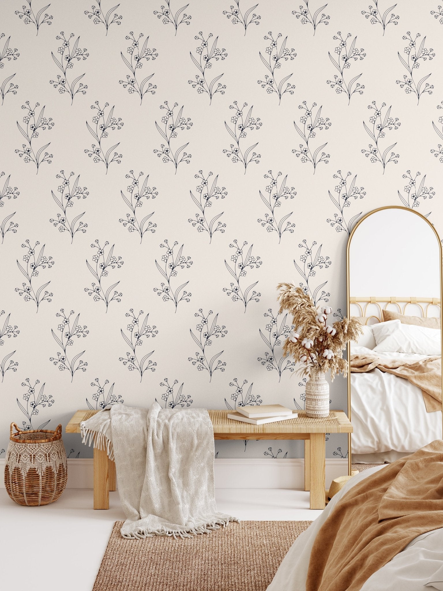 A bohemian style bedroom with aesthetic sketched twig peel and stick wallpaper