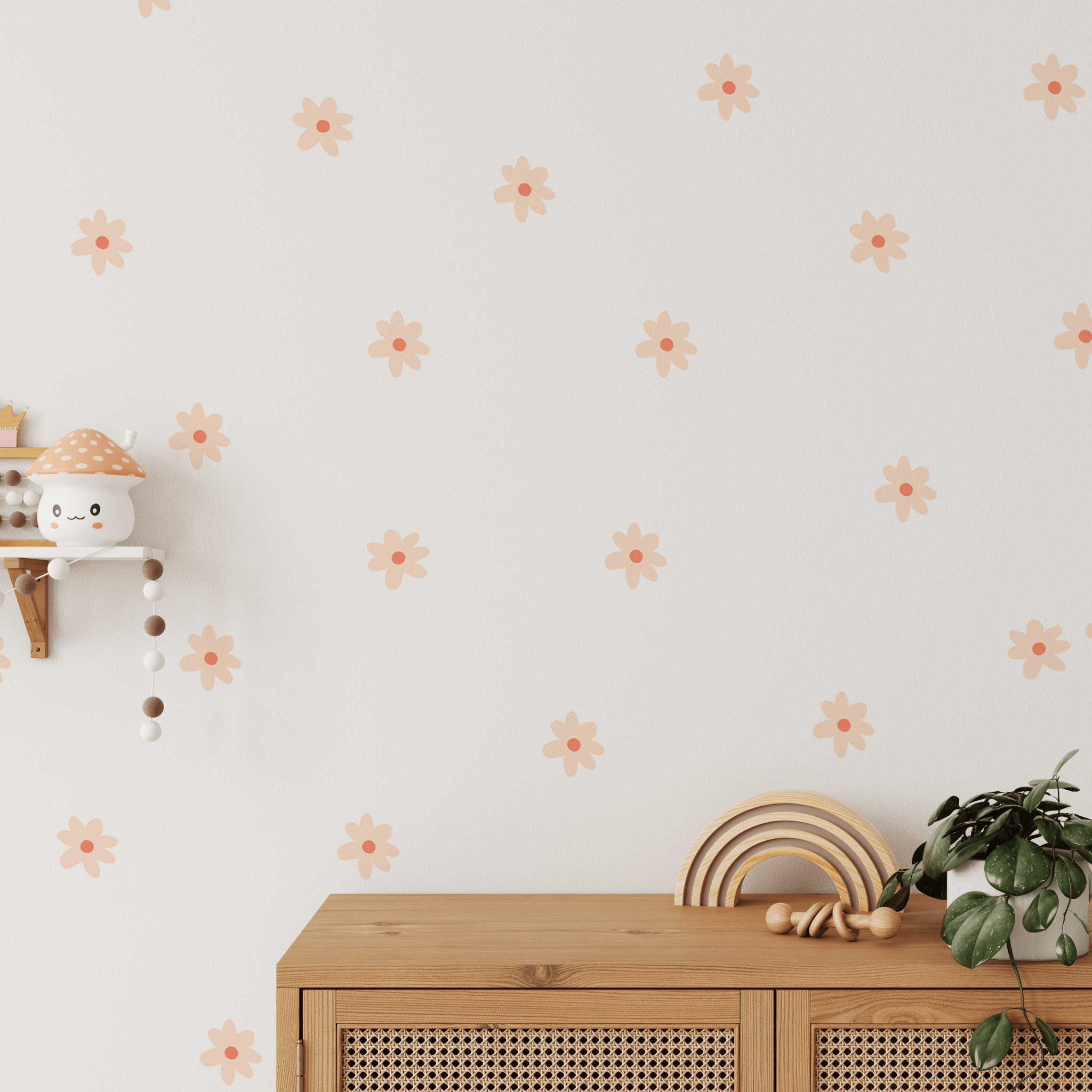 Small daisy wall stickers placed behind a wood dresser and decorated with kid's toys