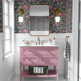 floral wallpaper in bathroom with pink sink vanity and gold mirror with two gold light sconces