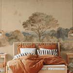 A warm and inviting bedroom with a wall adorned by a high-quality peel and stick mural illustrating a vintage landscape with trees. The room includes a wooden bed with orange bedding, striped pillows, and pendant lights.
