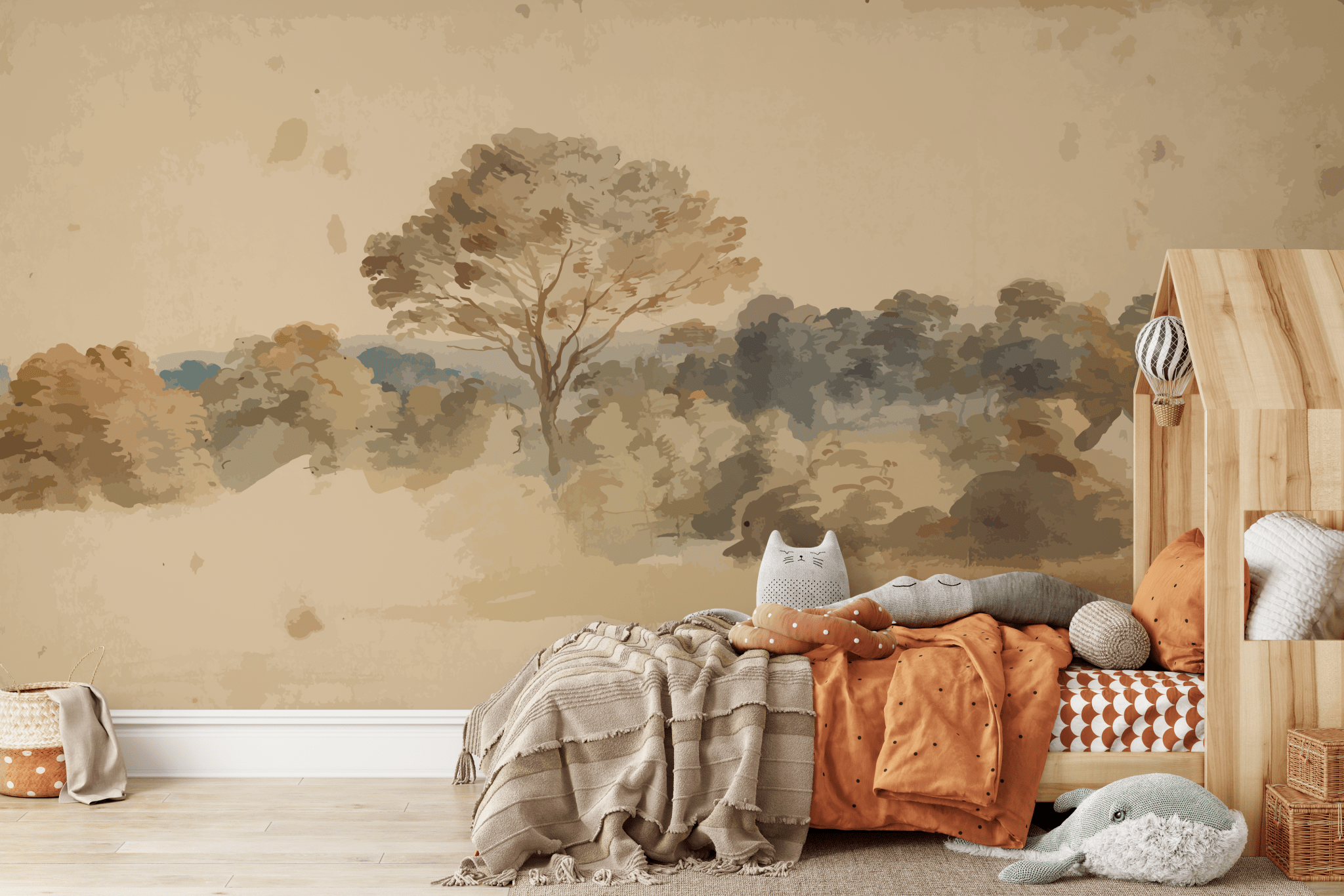 A cozy children's room corner with a peel and stick wall mural depicting a vintage, impressionistic landscape with a large tree. The room is decorated with a plush cat pillow, a wooden bed frame with a knitted blanket, and a woven basket.
